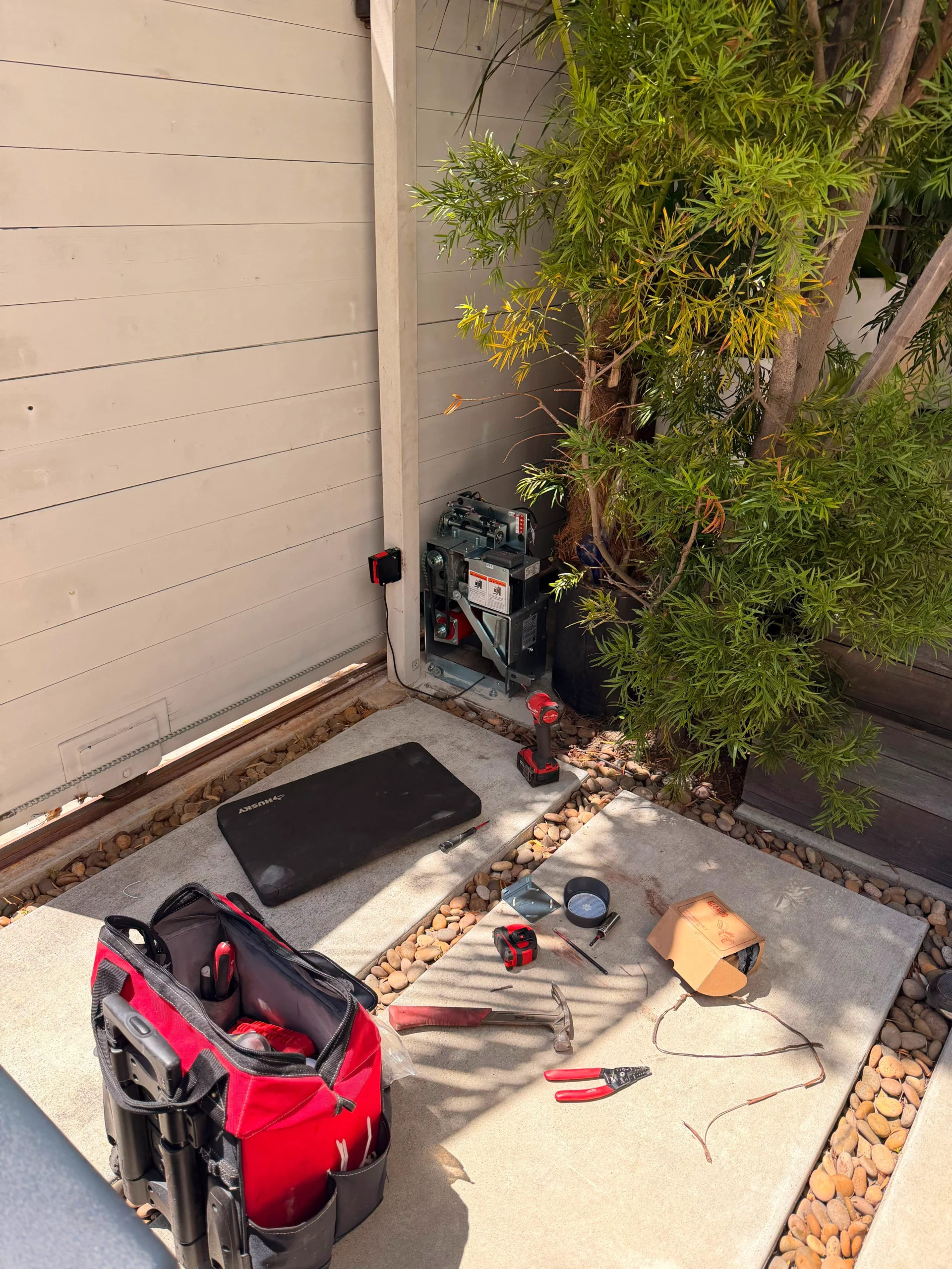 Emergency electric gate repair technician working on a gate motor in Calabasas, CA