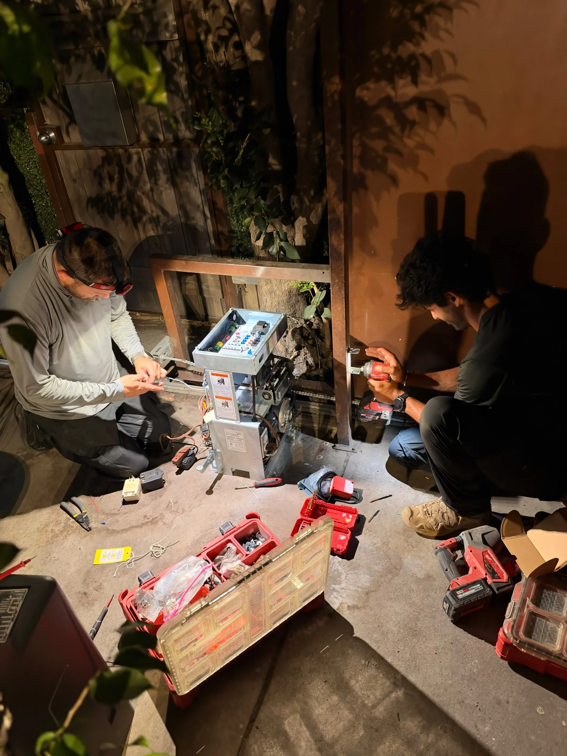 Technician inspecting an electric gate motor in Los Angeles