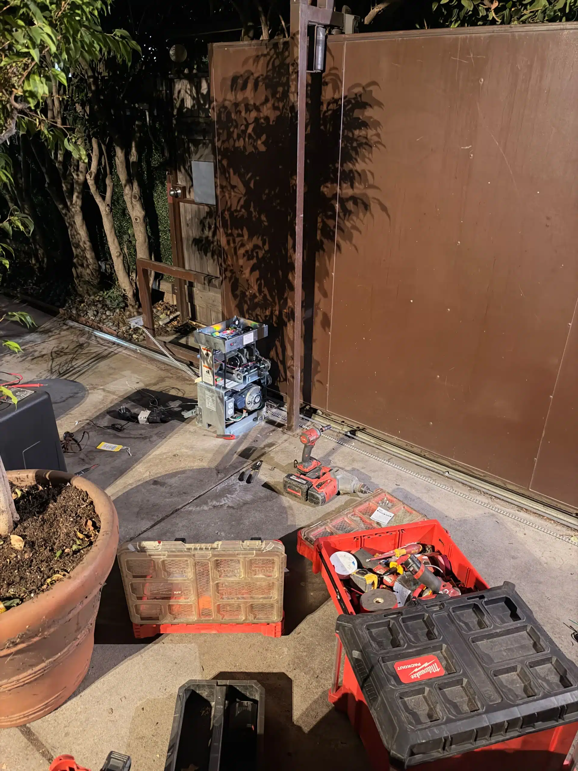 gate repair services anaheim technician fixing an automatic driveway gate